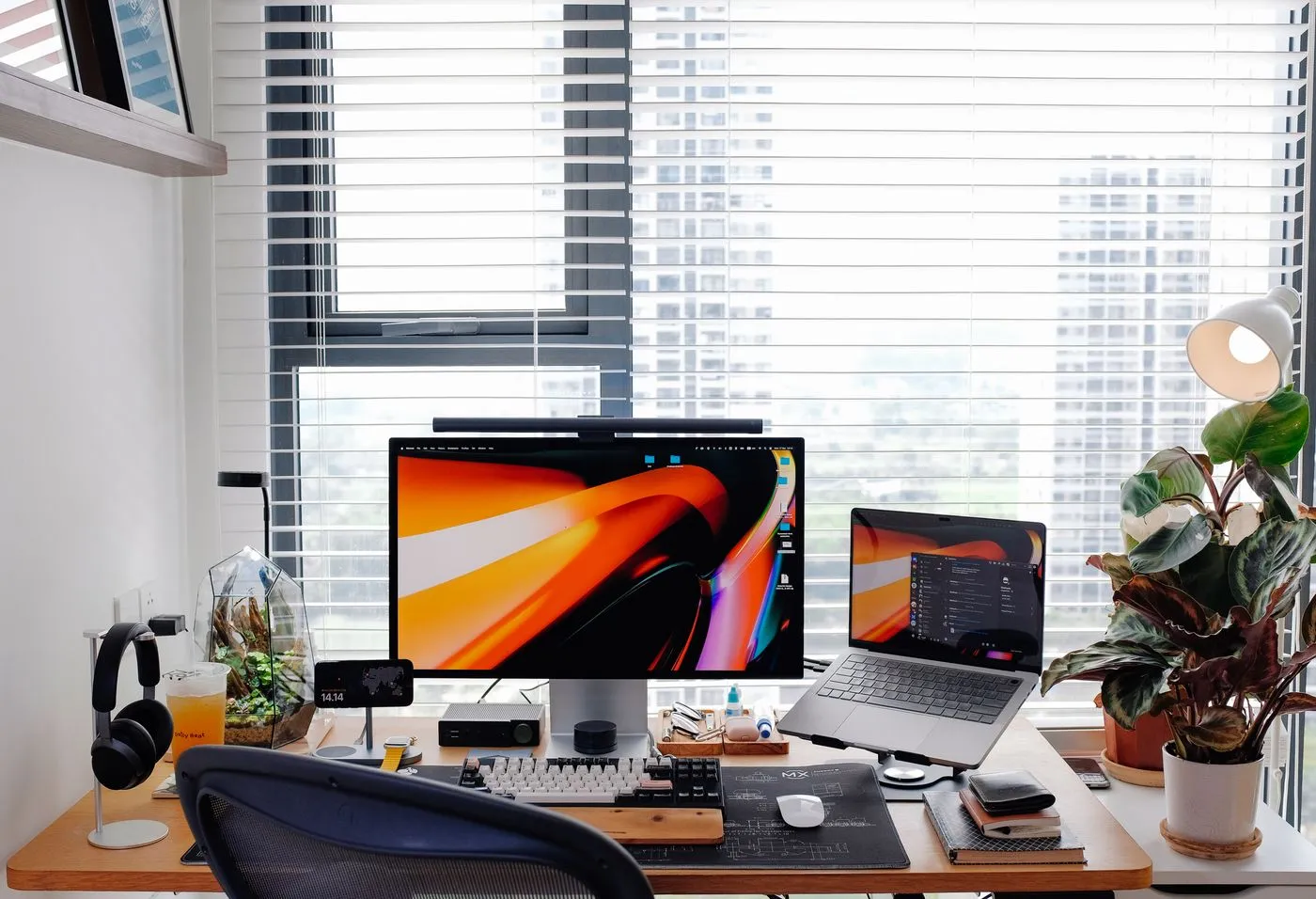 Modern desk setup with a monitor and laptop for design work