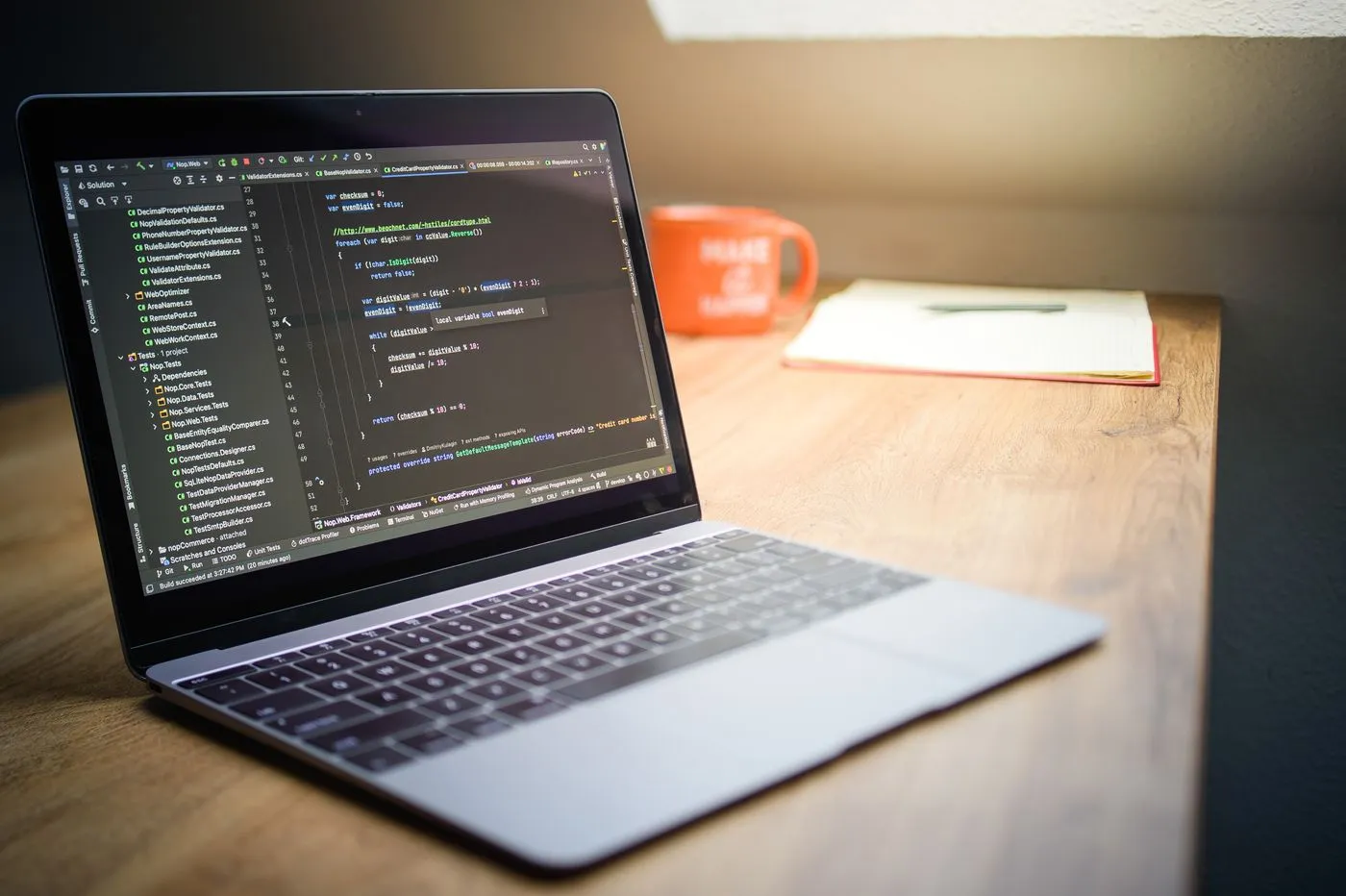 Laptop showing code on a desk during website build work