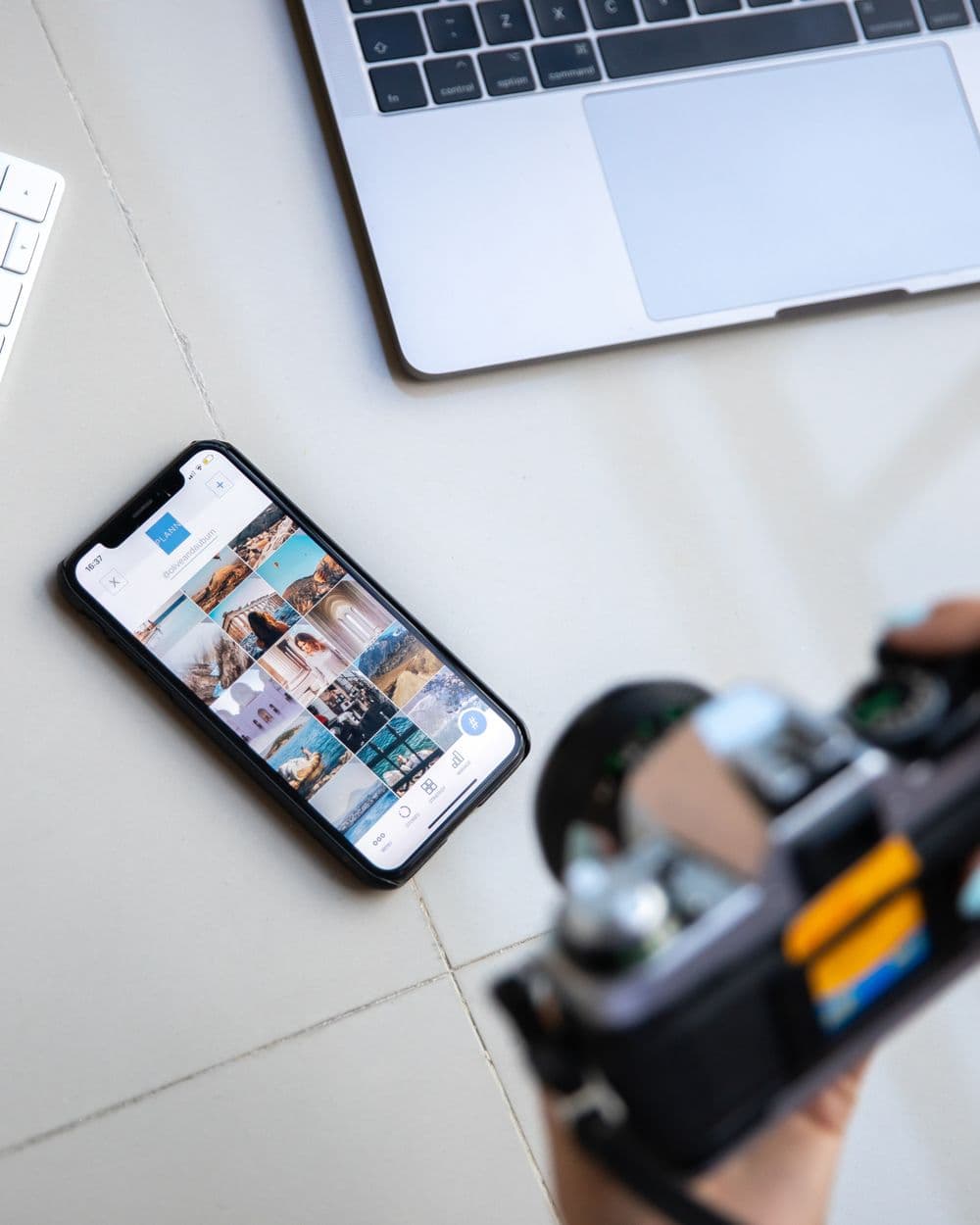 Camera, phone and laptop in a content-creation setup